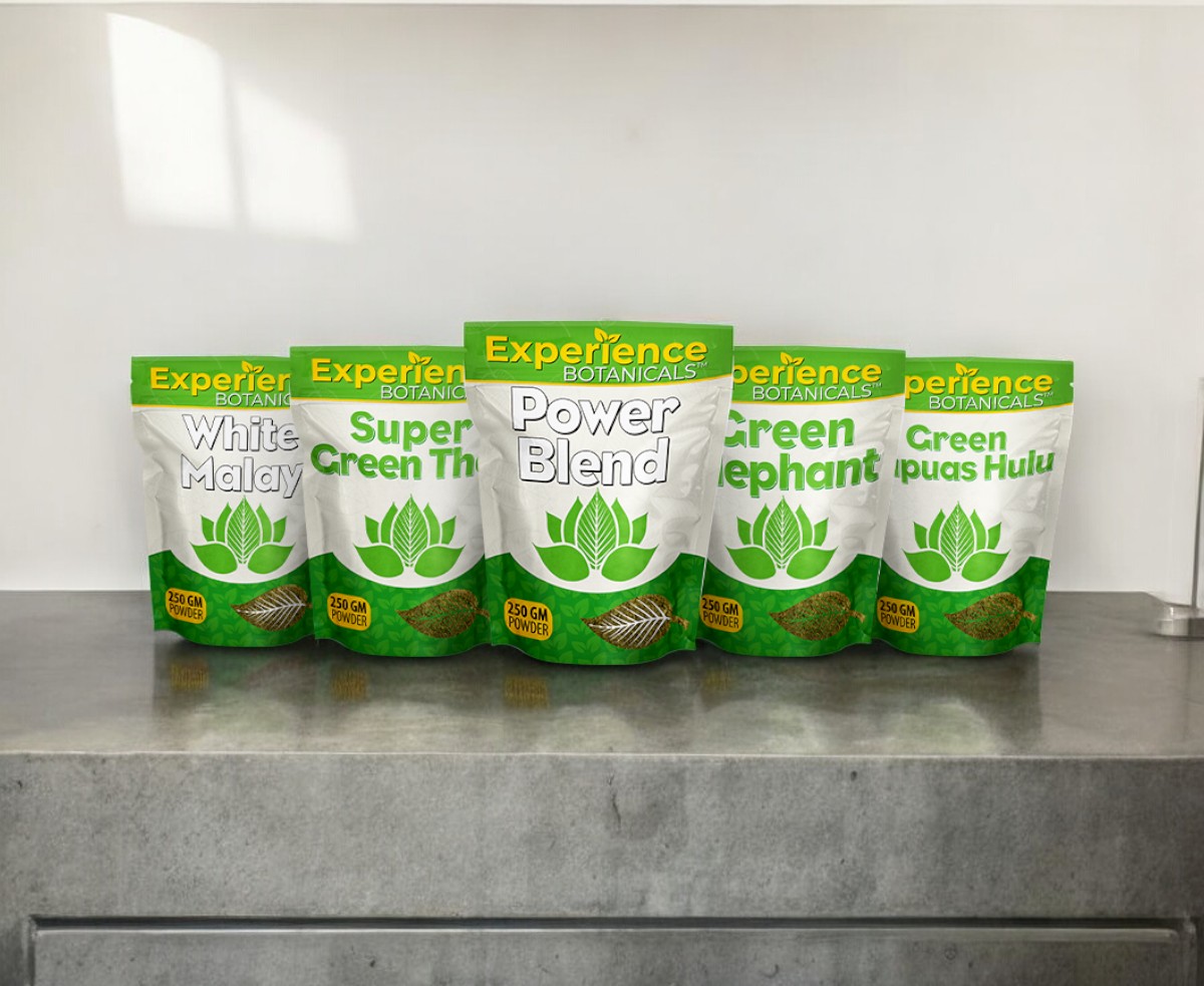 Five packages of the Experience Powder Bags Split Kilo Bundle are lined up on a gray countertop, showcasing various blends such as White Malay and Green Elephant, providing a unique selection for enthusiasts to choose four different options.
