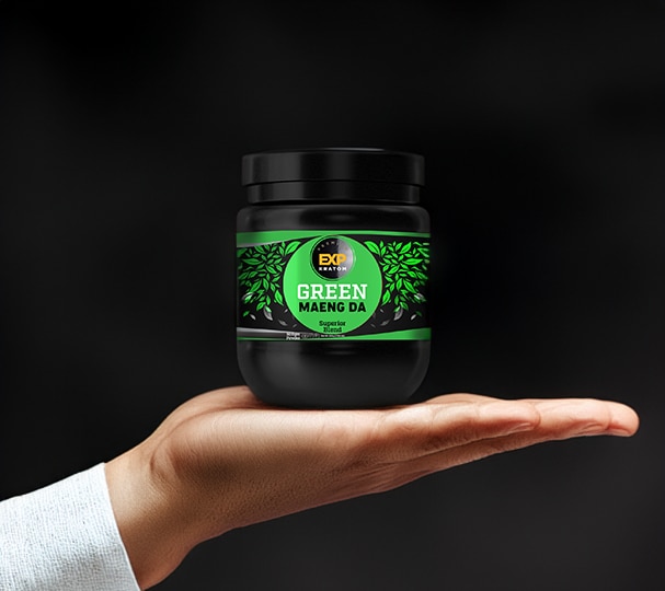 A hand is holding an EXP Premium Green Maeng Da Blend Powder container labeled "Green Maeng Da" against a black background.